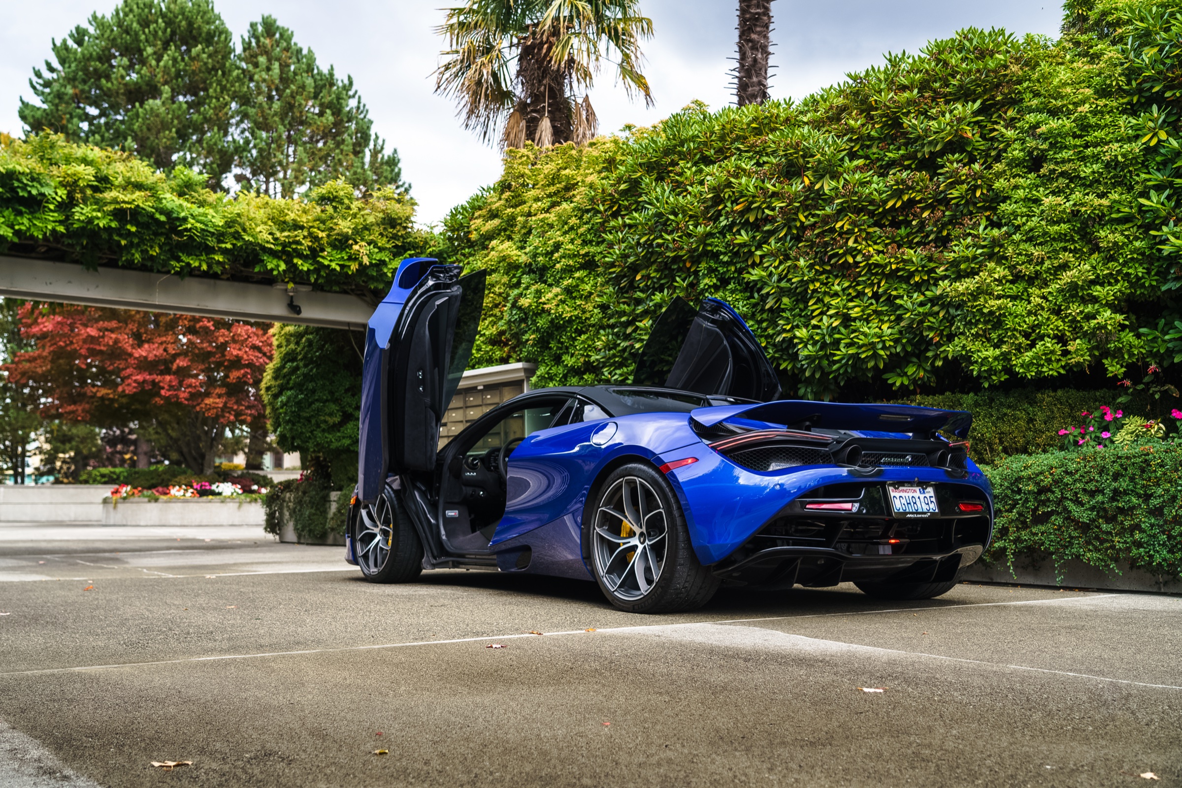 Blue McLaren 720S Spider with doors up